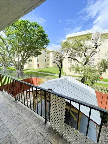 a view of a patio with two chairs and a table