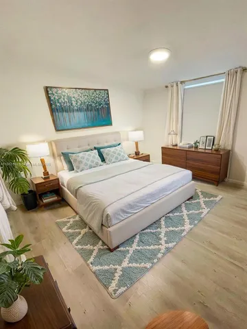 a bedroom with a bed table and a couch