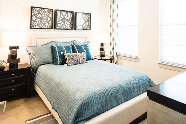 a bedroom with a bed and a window