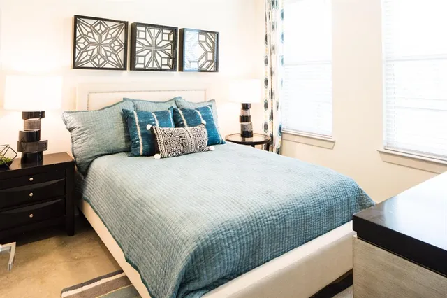 a bedroom with a bed and a window