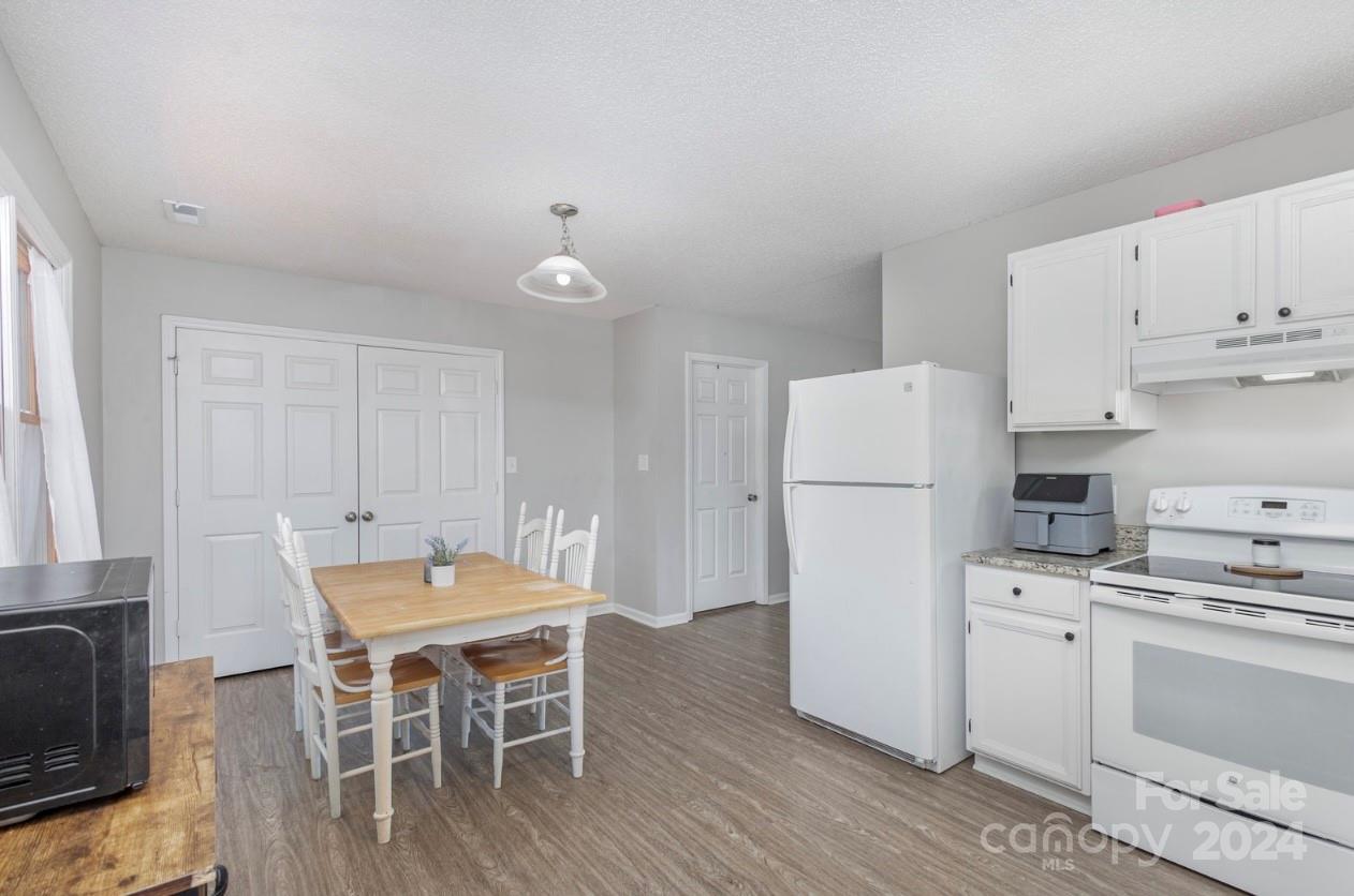 3614 White Store Road Wingate, NC 28174 - Photo 7 of 19 a kitchen with a table chairs refrigerator and cabinets