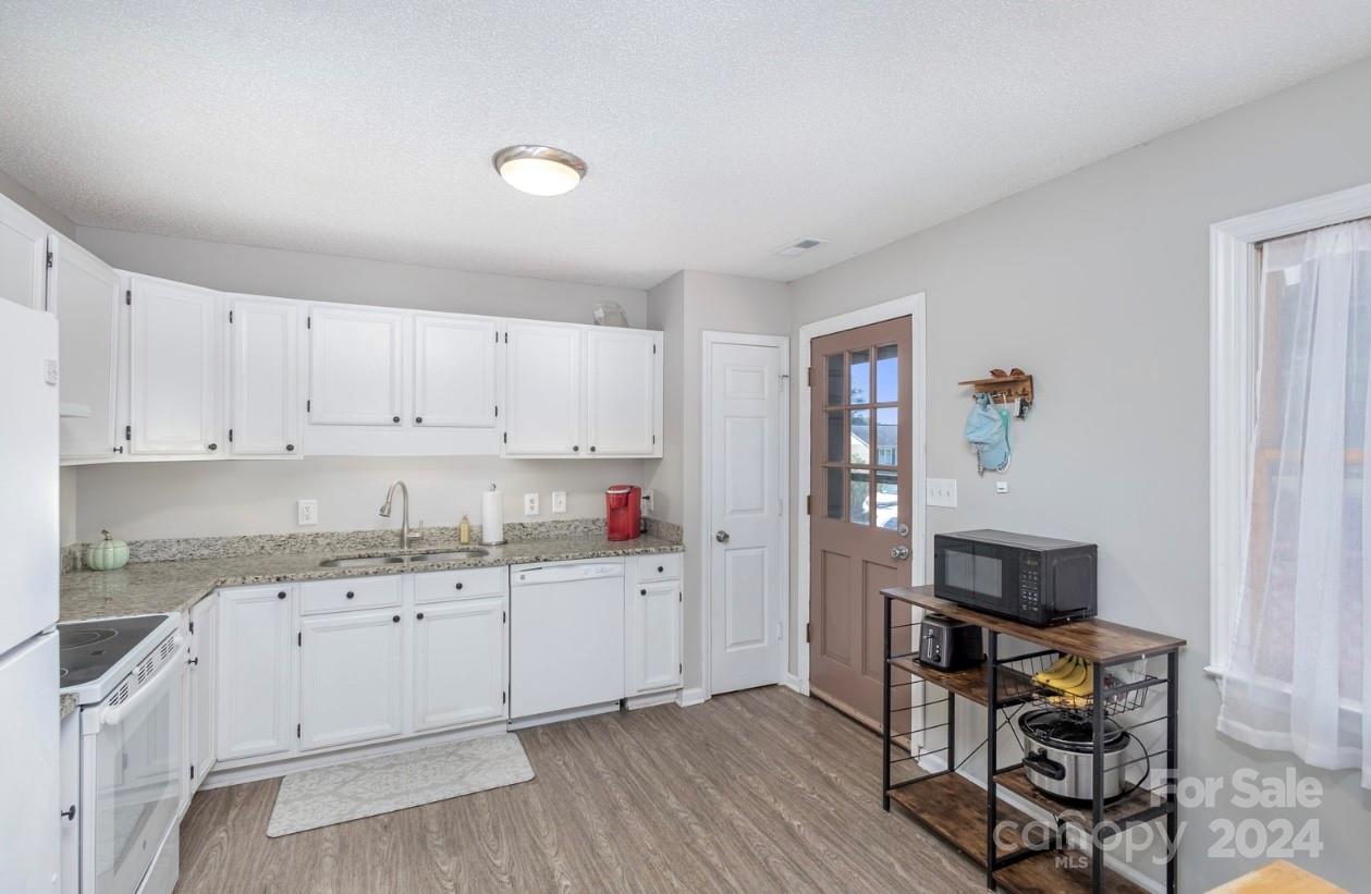 3614 White Store Road Wingate, NC 28174 - Photo 8 of 19 a kitchen with a sink cabinets and wooden floor