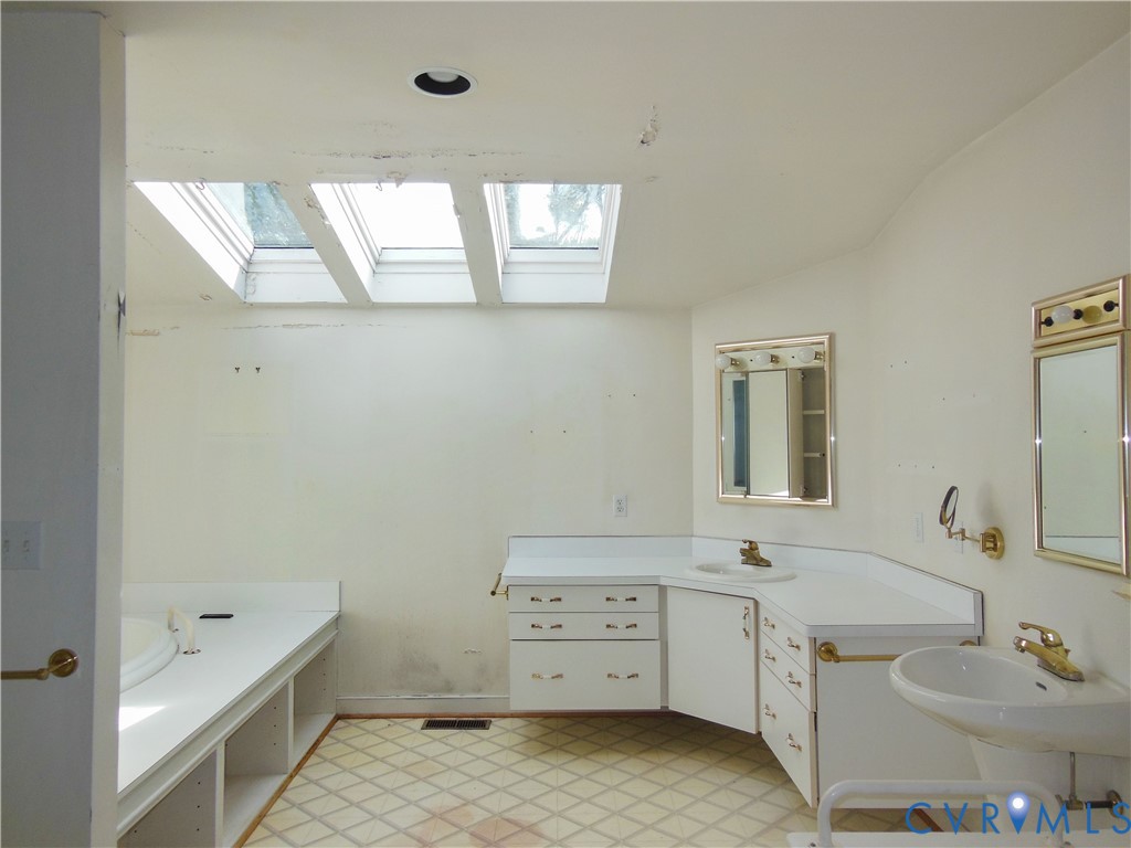 8218 Overbury Road Richmond, VA 23227 - Photo 14 of 37 a room with a sink and a mirror