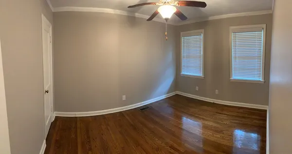 wooden floor in an empty room with a window