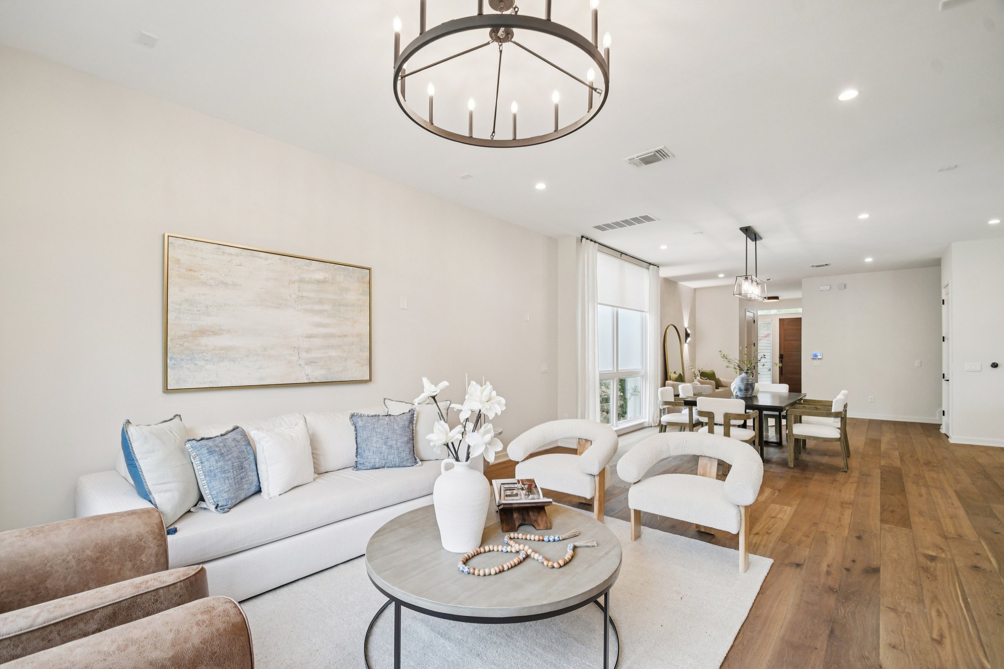 2518 Watkins Way Austin, TX 78746 - Photo 8 of 28 a living room with furniture a dining table and a chandelier