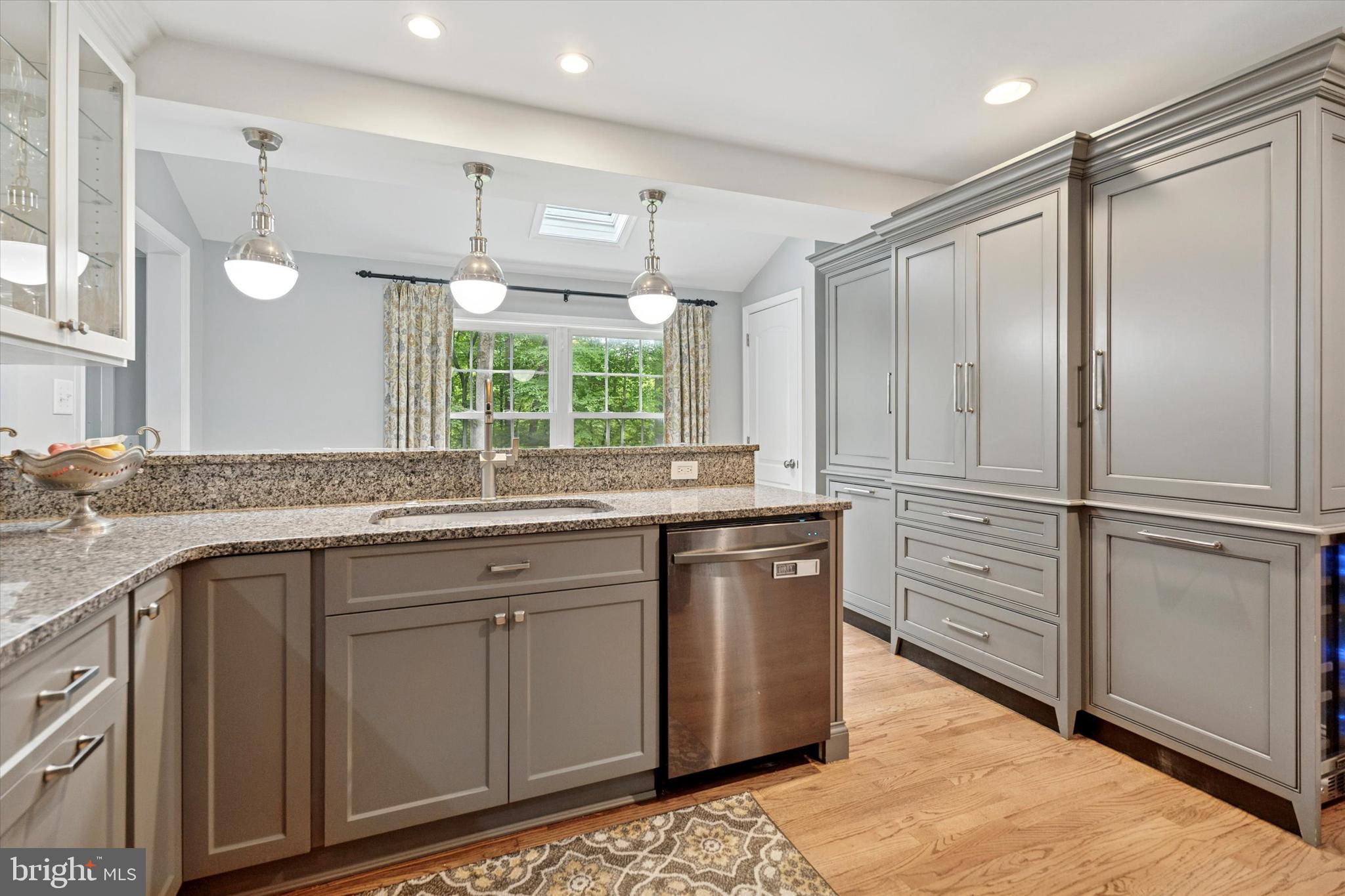 758 North Valley Forge Road Devon, PA 19333 - Photo 16 of 39 a kitchen with stainless steel appliances granite countertop a sink cabinets and wooden floor