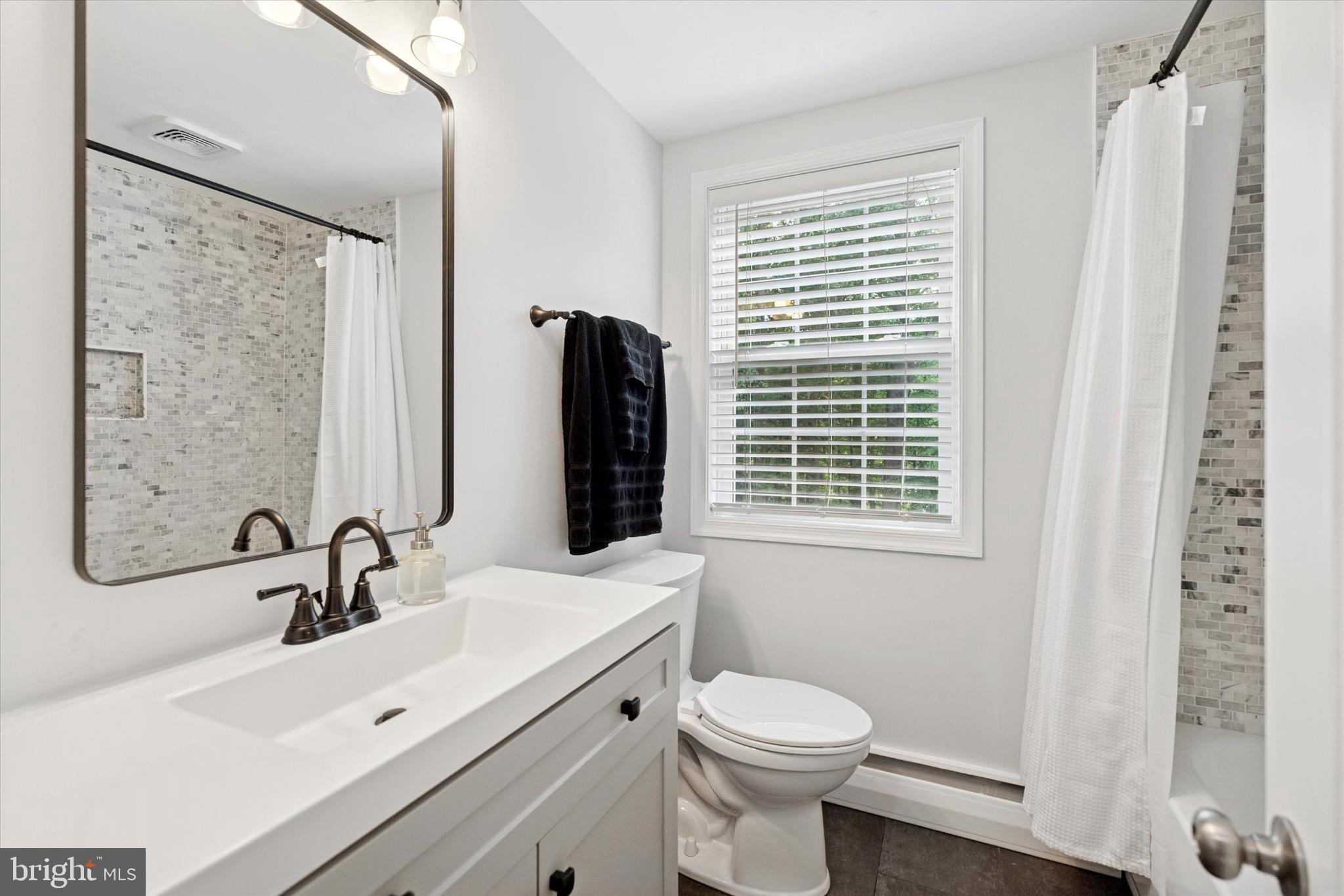 758 North Valley Forge Road Devon, PA 19333 - Photo 30 of 39 a bathroom with a sink a toilet and a mirror