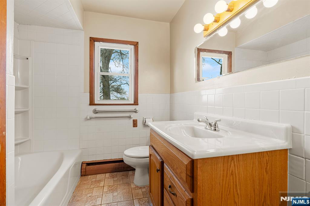 677 Greeley Avenue Fairview, NJ 07022 - Photo 12 of 34 a bathroom with a sink and a mirror