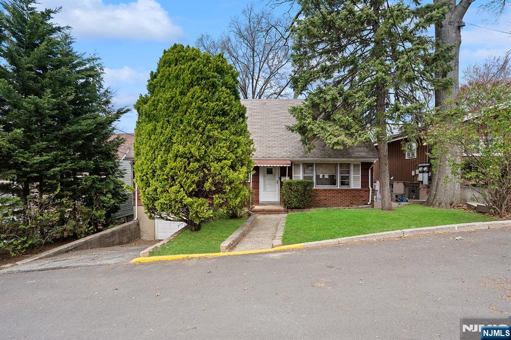 677 Greeley Avenue Fairview, NJ 07022 - Photo 2 of 34 a view of a house with a garden and pathway