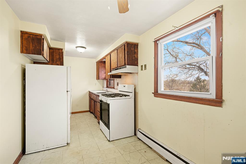 677 Greeley Avenue Fairview, NJ 07022 - Photo 23 of 34 a kitchen with a refrigerator and a stove top oven