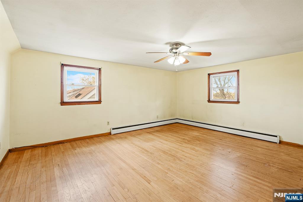 677 Greeley Avenue Fairview, NJ 07022 - Photo 24 of 34 a view of an empty room with wooden floor