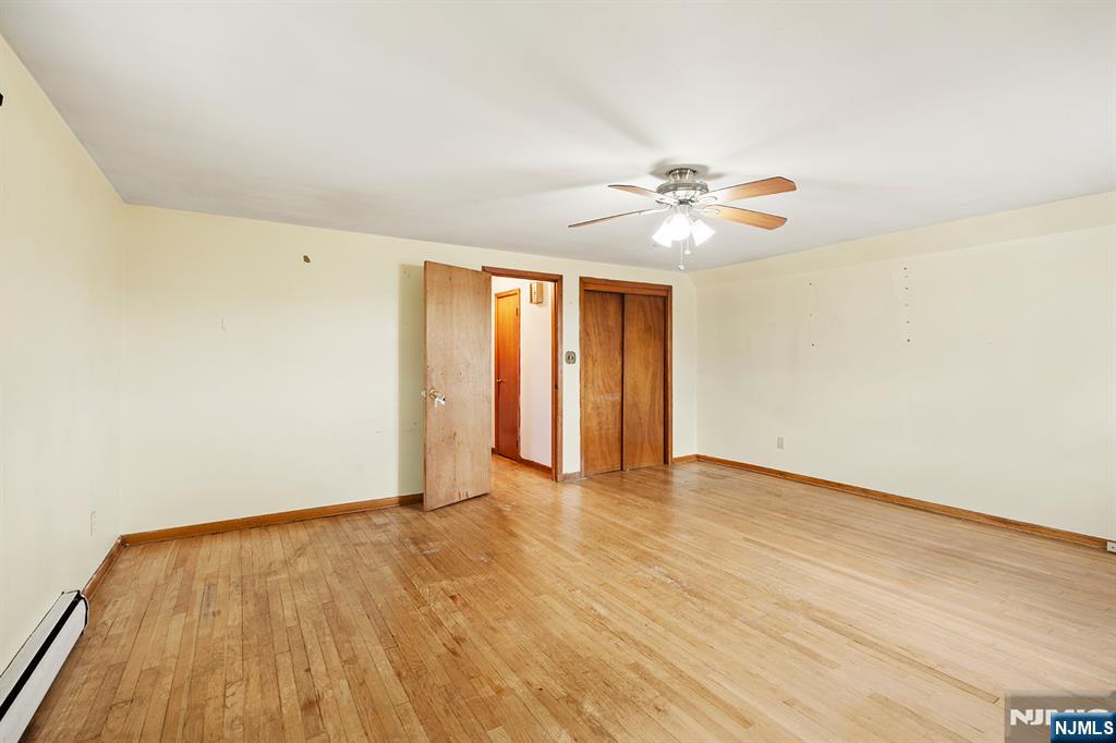 677 Greeley Avenue Fairview, NJ 07022 - Photo 26 of 34 wooden floor in an empty room