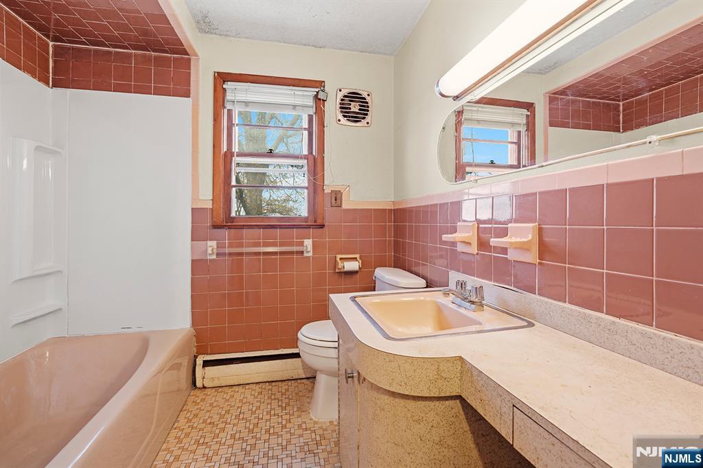 677 Greeley Avenue Fairview, NJ 07022 - Photo 27 of 34 a bathroom with a sink a toilet and bathtub