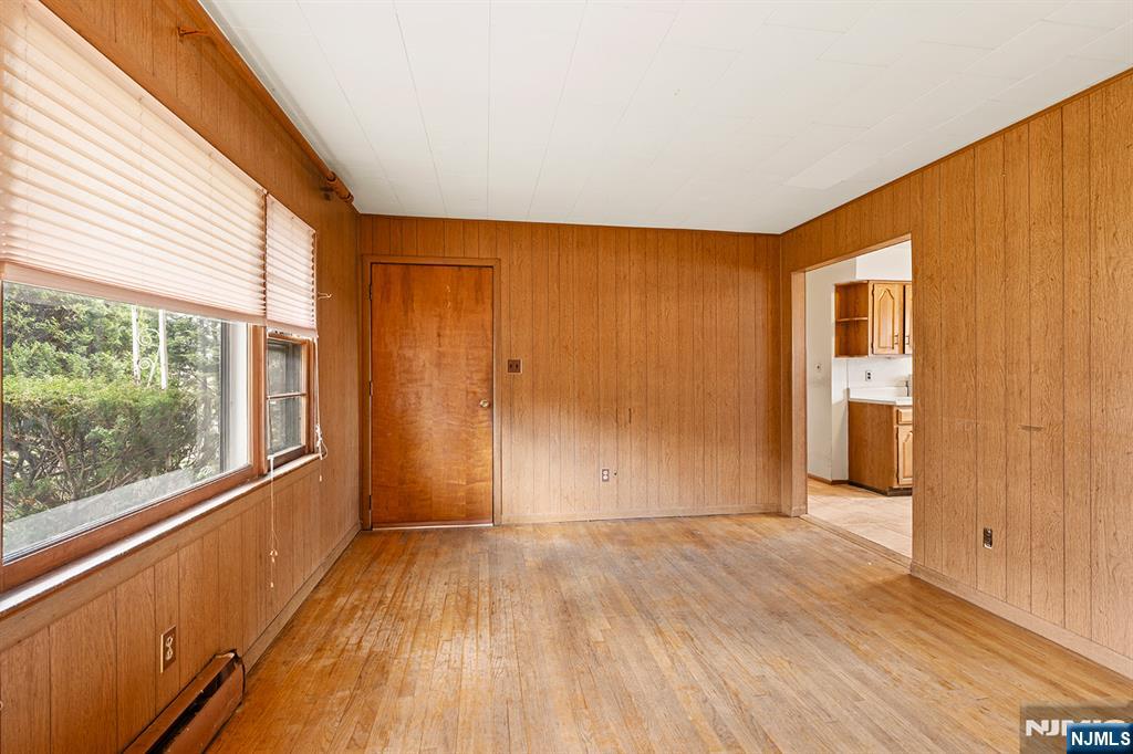 677 Greeley Avenue Fairview, NJ 07022 - Photo 6 of 34 a view of hallway with wooden floor and stairs