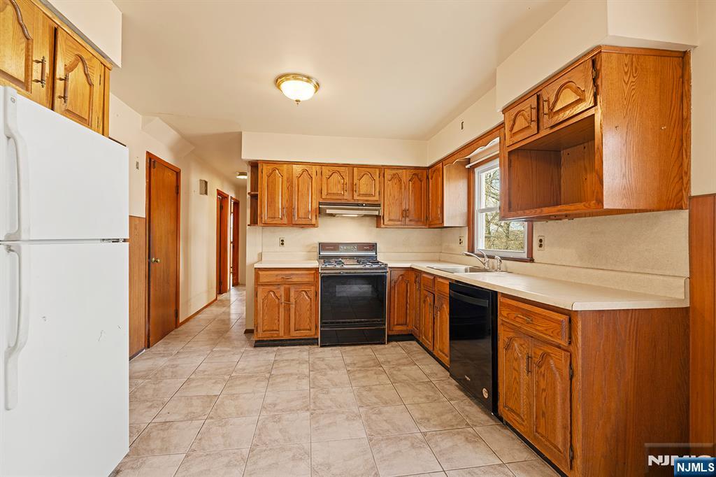 677 Greeley Avenue Fairview, NJ 07022 - Photo 10 of 34 a kitchen with stainless steel appliances granite countertop a refrigerator and a sink