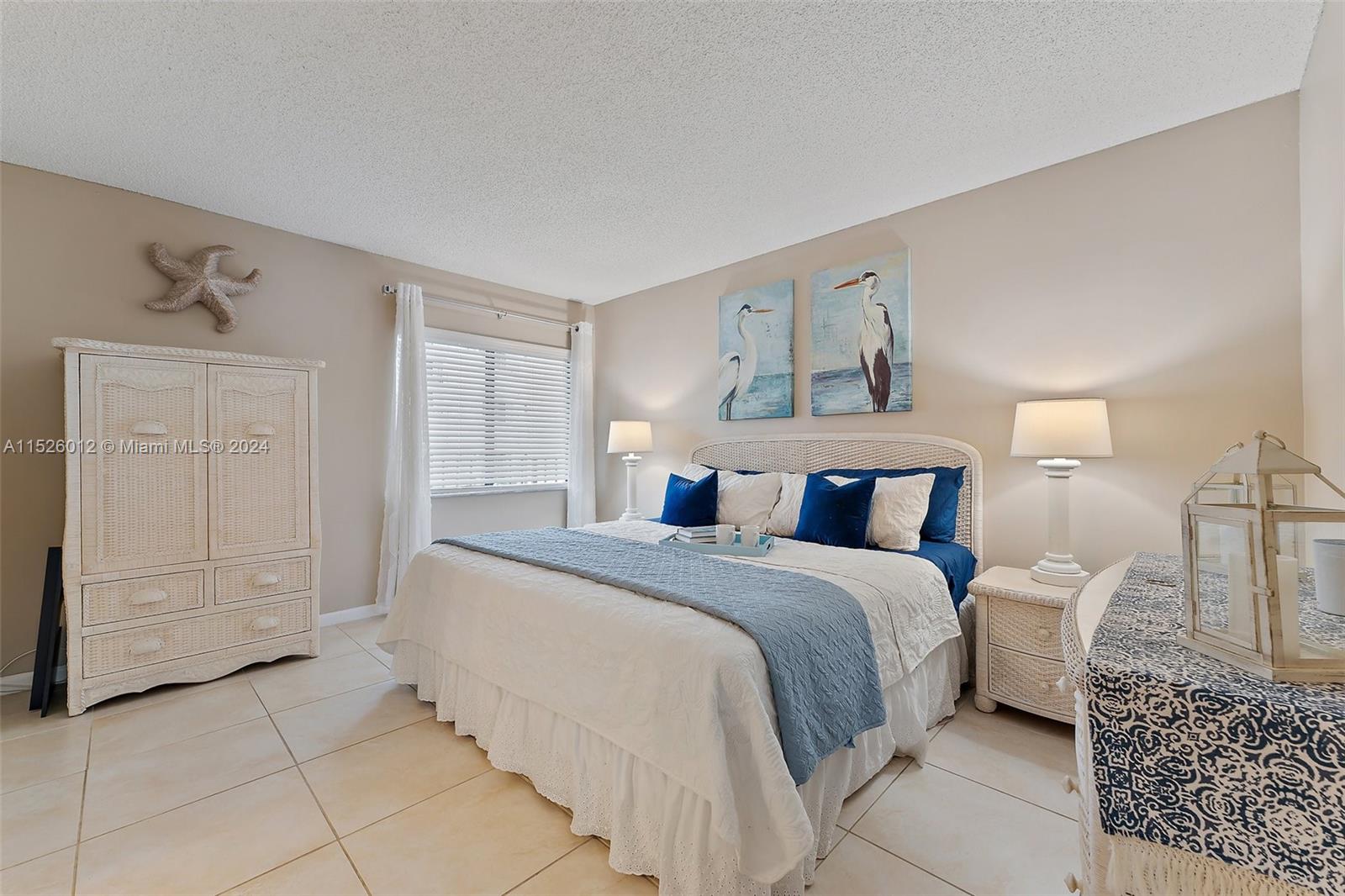 1605 Highway 1, Unit A406 Jupiter, FL 33477 - Photo 15 of 26 a spacious bedroom with a bed and a cabinets