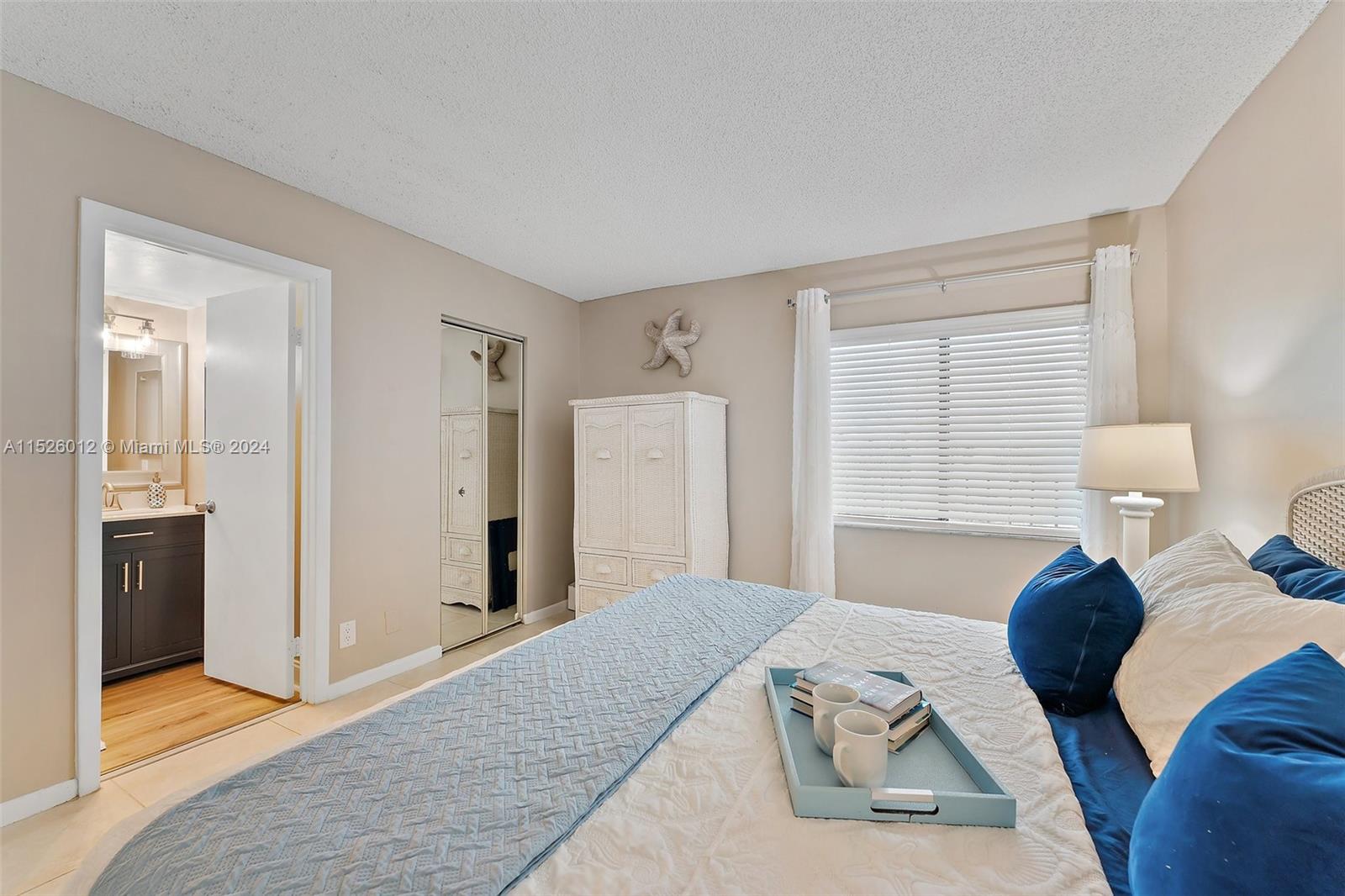 1605 Highway 1, Unit A406 Jupiter, FL 33477 - Photo 18 of 26 a bedroom with a bed and a dresser