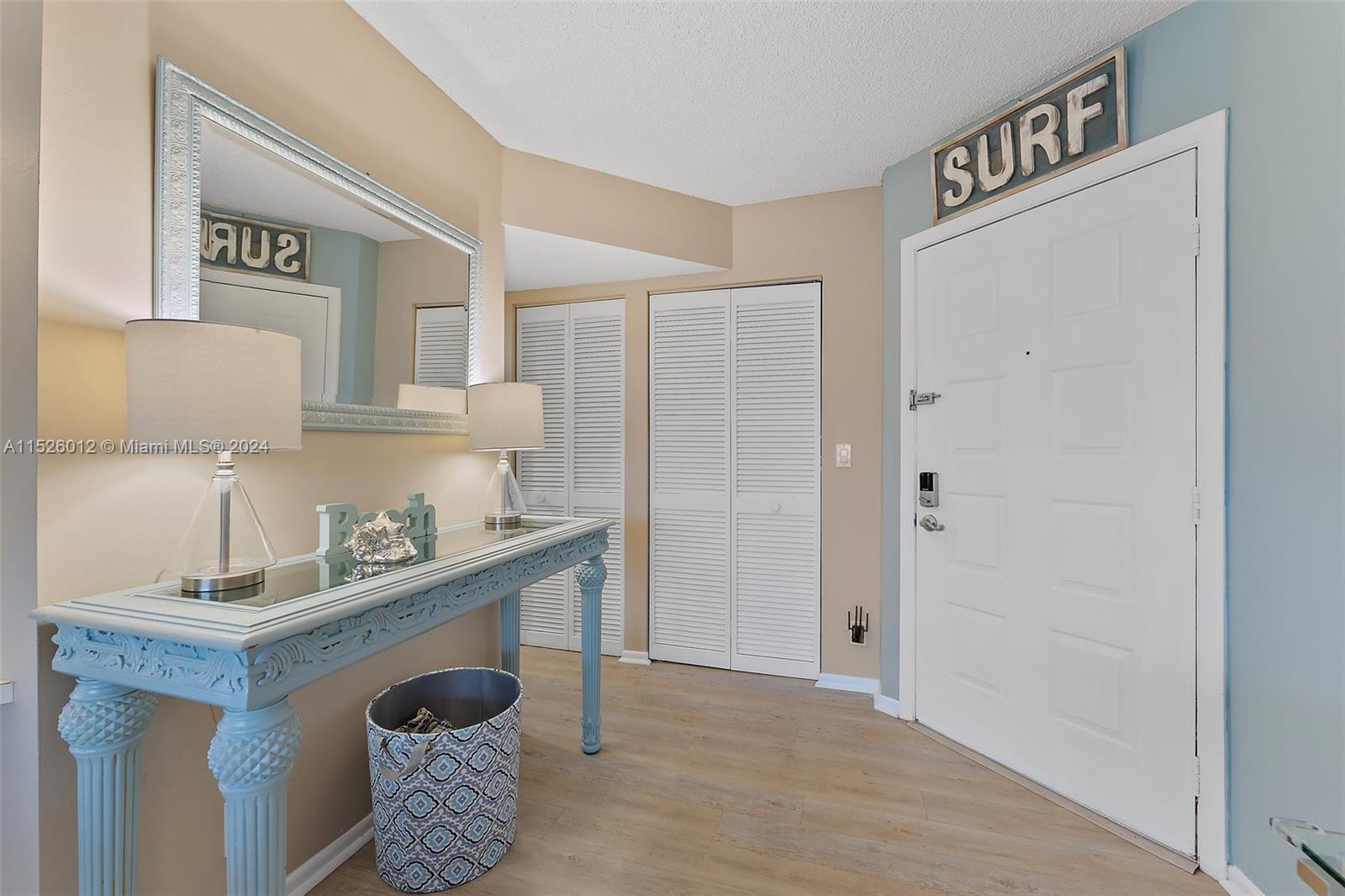 1605 Highway 1, Unit A406 Jupiter, FL 33477 - Photo 5 of 26 a room with furniture and a lamp