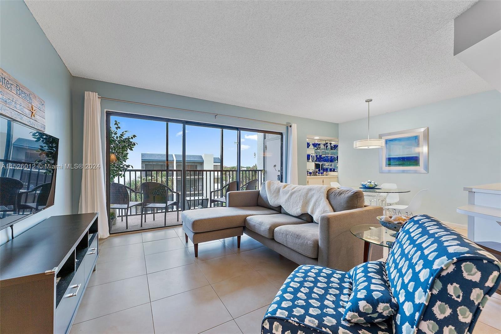 1605 Highway 1, Unit A406 Jupiter, FL 33477 - Photo 7 of 26 a living room with furniture and a flat screen tv