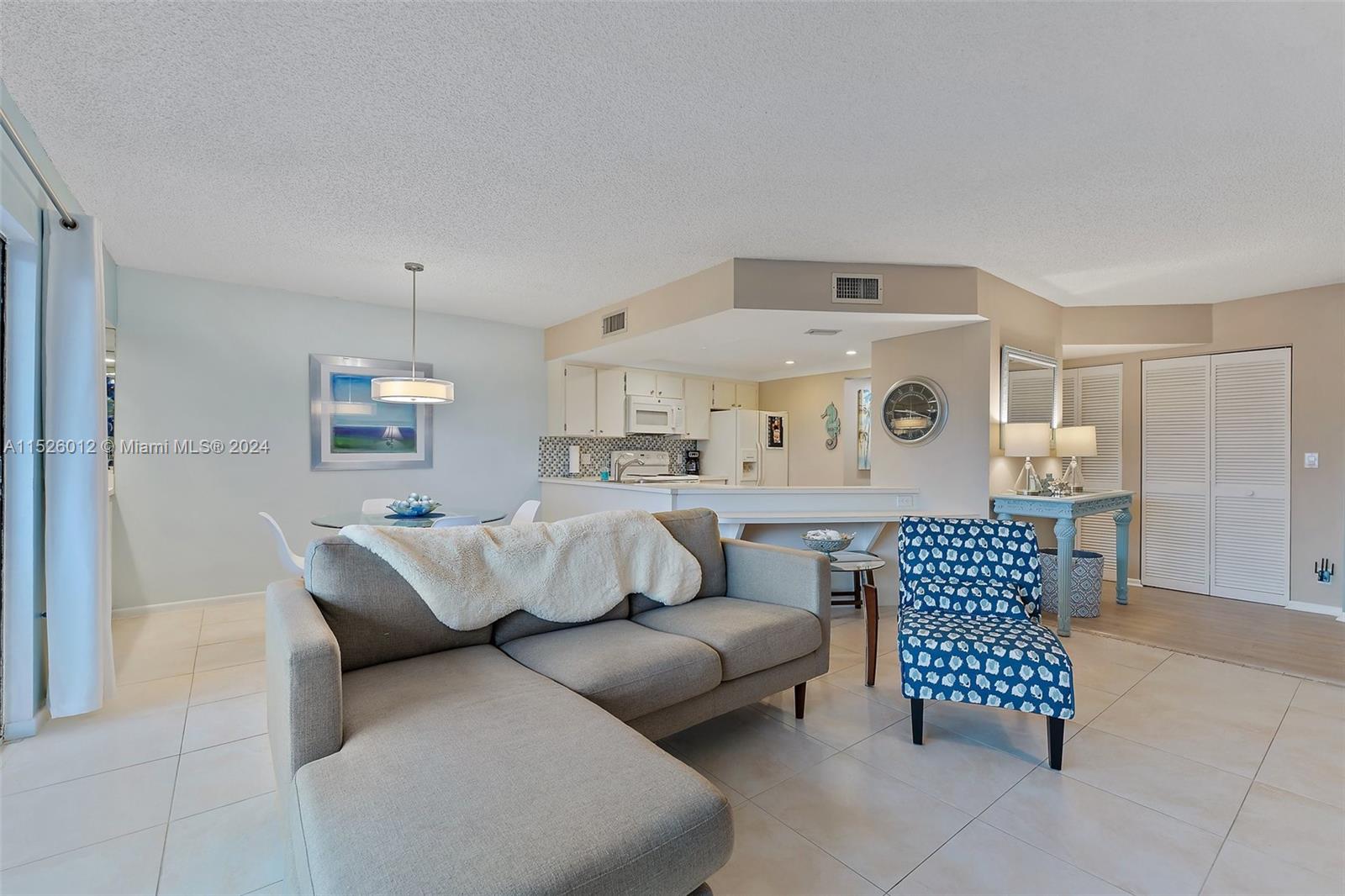 1605 Highway 1, Unit A406 Jupiter, FL 33477 - Photo 9 of 26 a living room with furniture and a couch