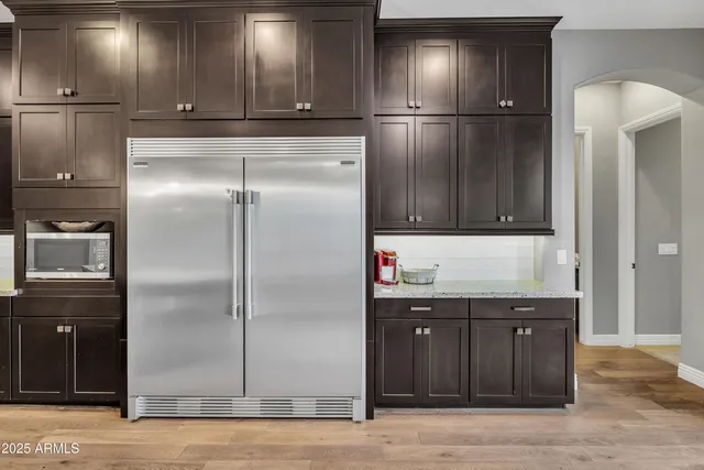 a kitchen with stainless steel appliances granite countertop a refrigerator and a sink