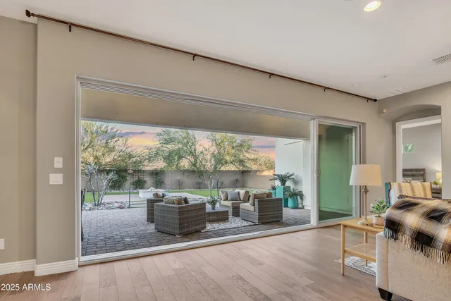 a living room with furniture and a floor to ceiling window