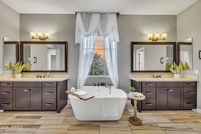 a spacious bathroom with a granite countertop tub sink and mirror