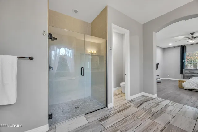 a bathroom with a tub shower and a sink