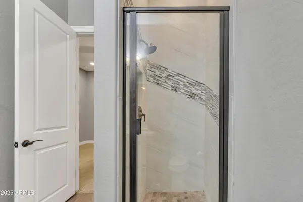 a bathroom with a glass shower door