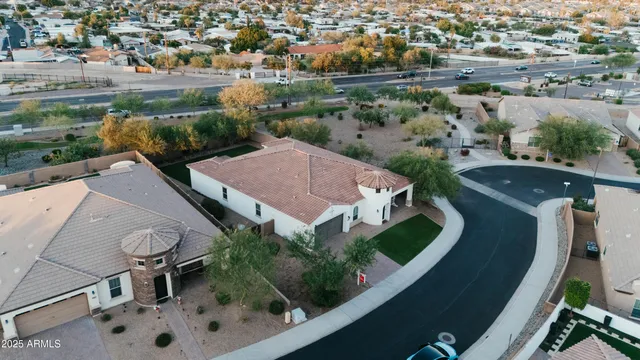 an aerial view of a house with garden space and street view