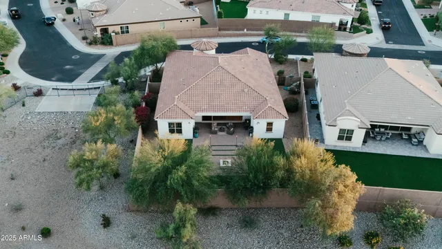 an aerial view of a house with yard and mountain view in back