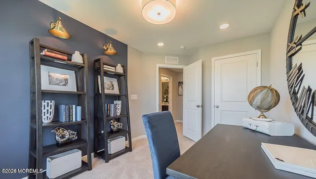 a living room with furniture and a book shelf