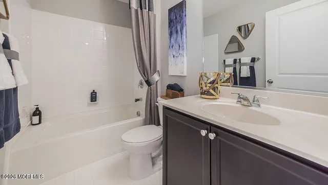 a bathroom with a granite countertop sink a toilet and a bathtub
