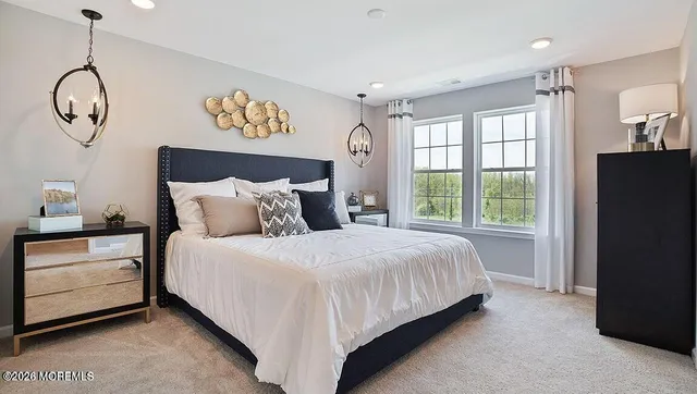 a bedroom with a bed mirror and window