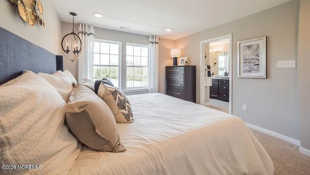 a bed sitting in a bedroom next to a window