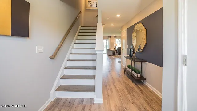 a view of entryway and hall with wooden floor