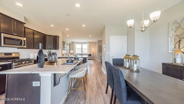 a kitchen with counter space appliances wooden floor and cabinets