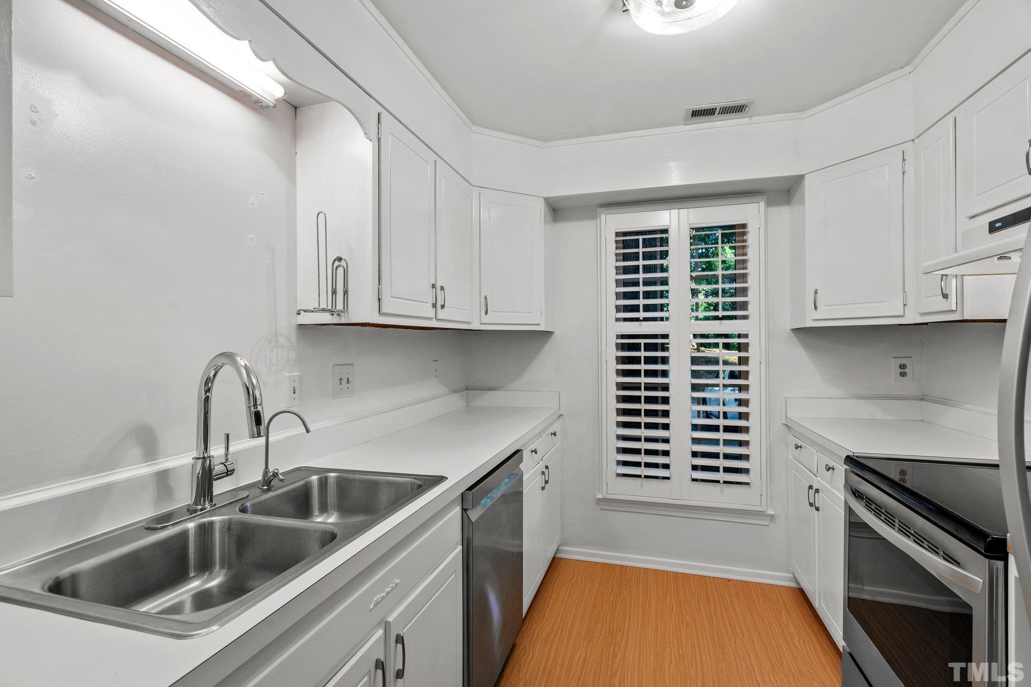 3169 Morningside Drive Raleigh, NC 27607 - Photo 14 of 36 a kitchen that has a sink cabinets counter space stainless steel appliances and cabinets