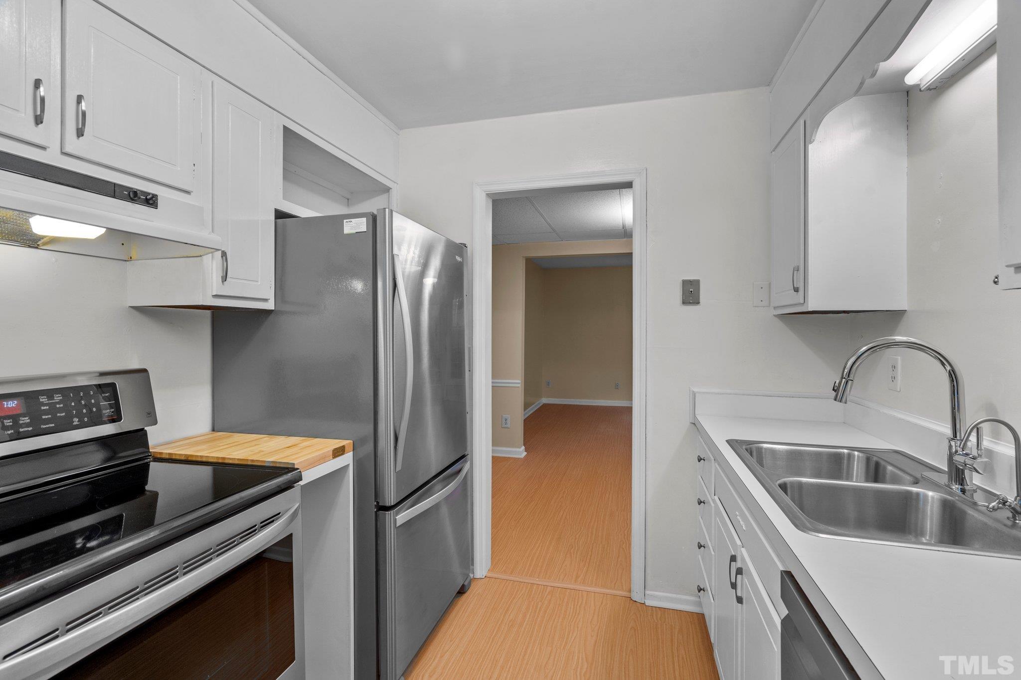 3169 Morningside Drive Raleigh, NC 27607 - Photo 15 of 36 a kitchen with a sink cabinets and stainless steel appliances