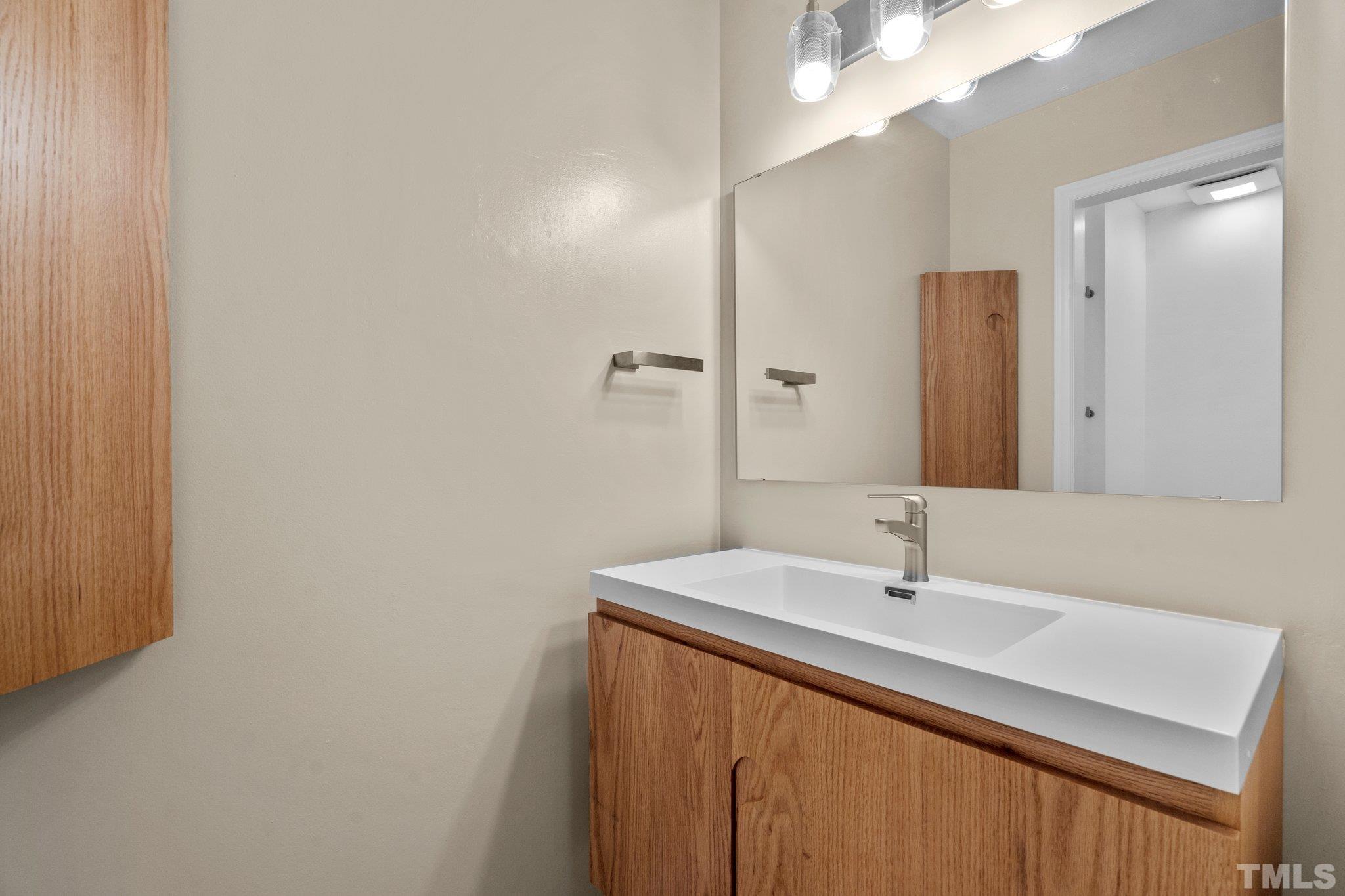 3169 Morningside Drive Raleigh, NC 27607 - Photo 30 of 36 a bathroom with a sink and a mirror