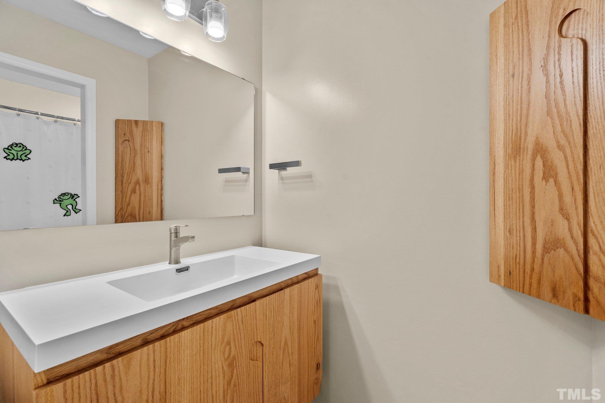 3169 Morningside Drive Raleigh, NC 27607 - Photo 32 of 36 a bathroom with a sink and a mirror