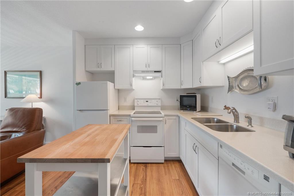 2929 Southeast Ocean Boulevard, Unit K7 Stuart, FL 34996 - Photo 11 of 18 a kitchen with a sink stove and refrigerator