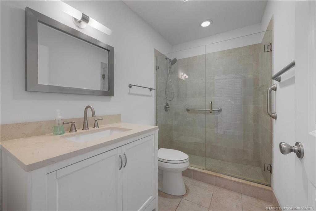 2929 Southeast Ocean Boulevard, Unit K7 Stuart, FL 34996 - Photo 12 of 18 a bathroom with a sink a toilet and shower