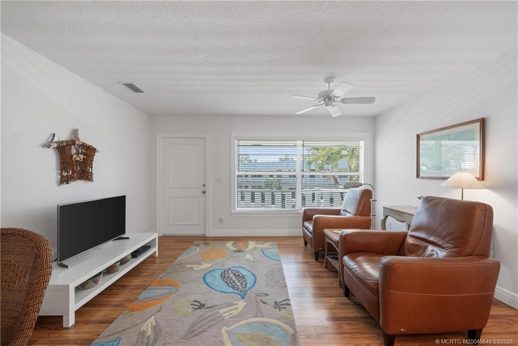 2929 Southeast Ocean Boulevard, Unit K7 Stuart, FL 34996 - Photo 4 of 18 a living room with furniture and a flat screen tv