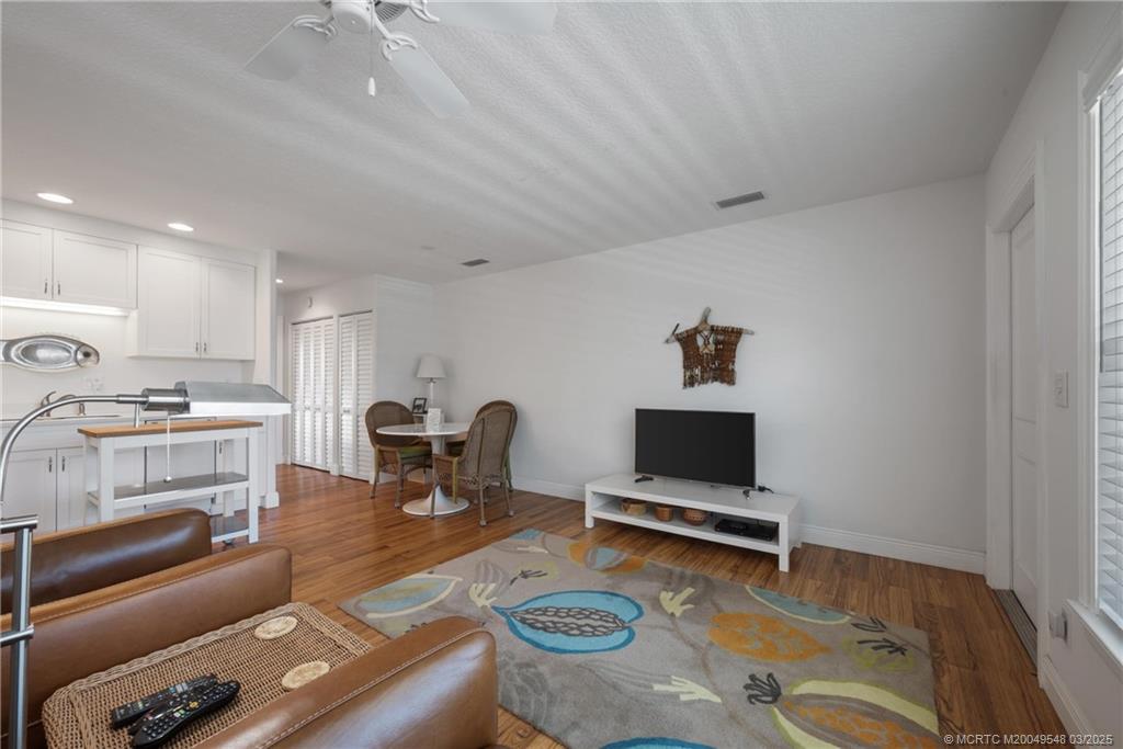 2929 Southeast Ocean Boulevard, Unit K7 Stuart, FL 34996 - Photo 6 of 18 a living room with furniture and a flat screen tv