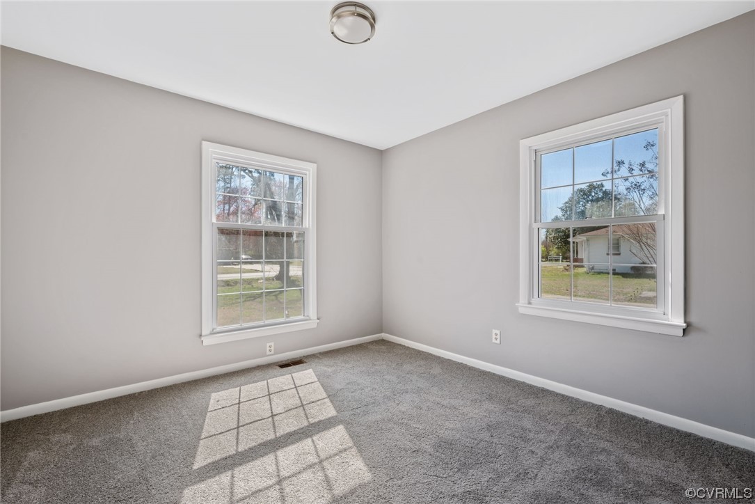607 Queens Creek Road Williamsburg, VA 23185 - Photo 11 of 13 an empty room with windows
