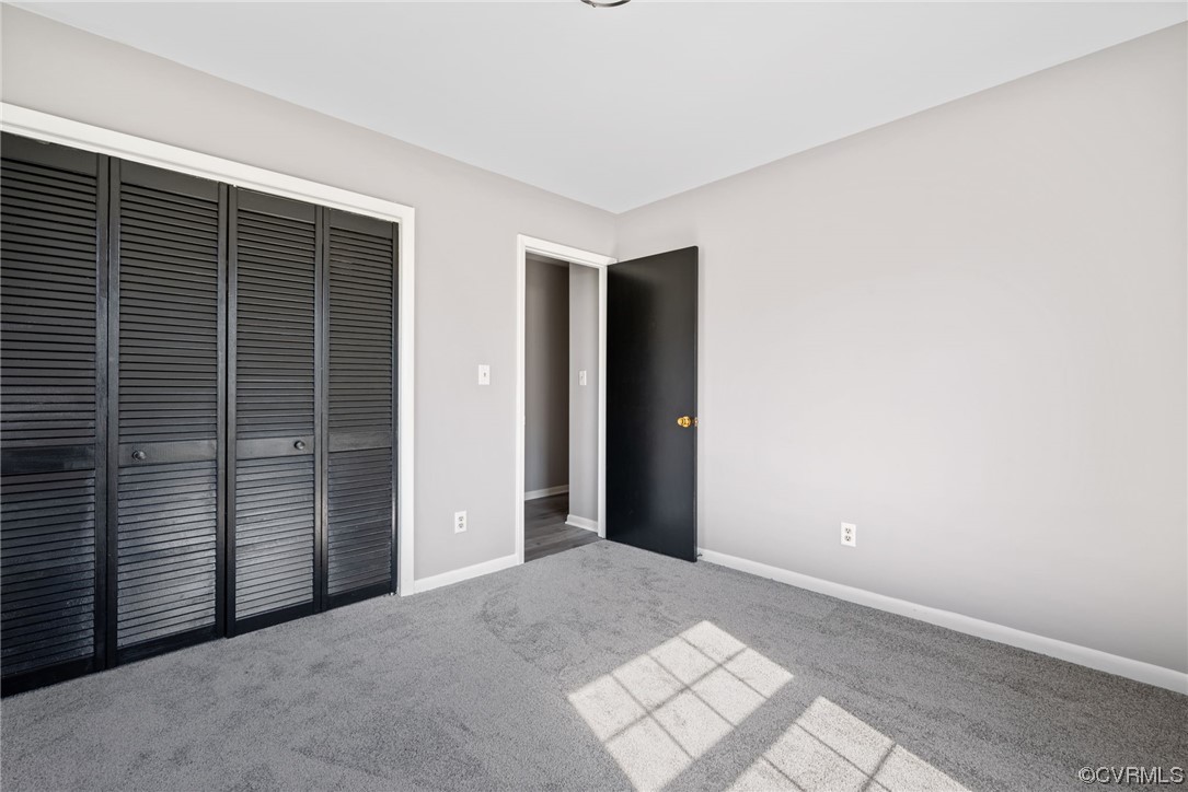 607 Queens Creek Road Williamsburg, VA 23185 - Photo 12 of 13 a view of an empty room with wooden door