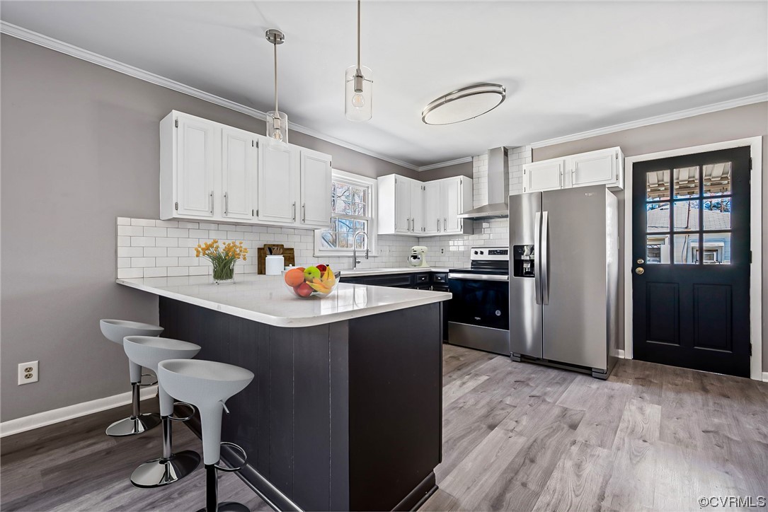 607 Queens Creek Road Williamsburg, VA 23185 - Photo 2 of 13 a kitchen with refrigerator cabinets and wooden floor