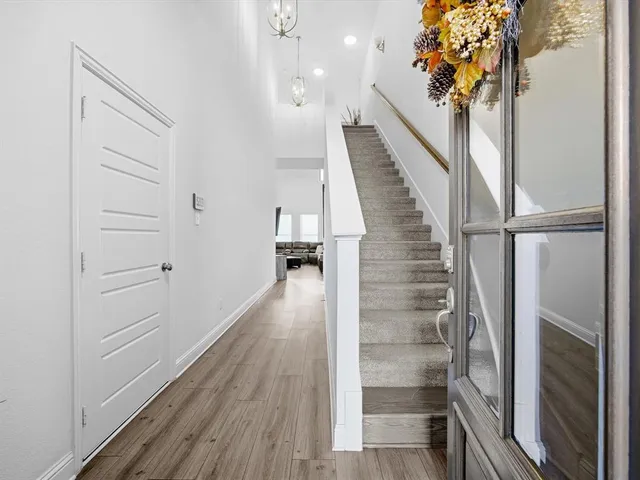 a view of entryway and hall with wooden floor