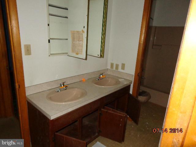 11008 Garrison Hollow Road Clear Spring, MD 21722 - Photo 16 of 30 a bathroom with a sink and a mirror